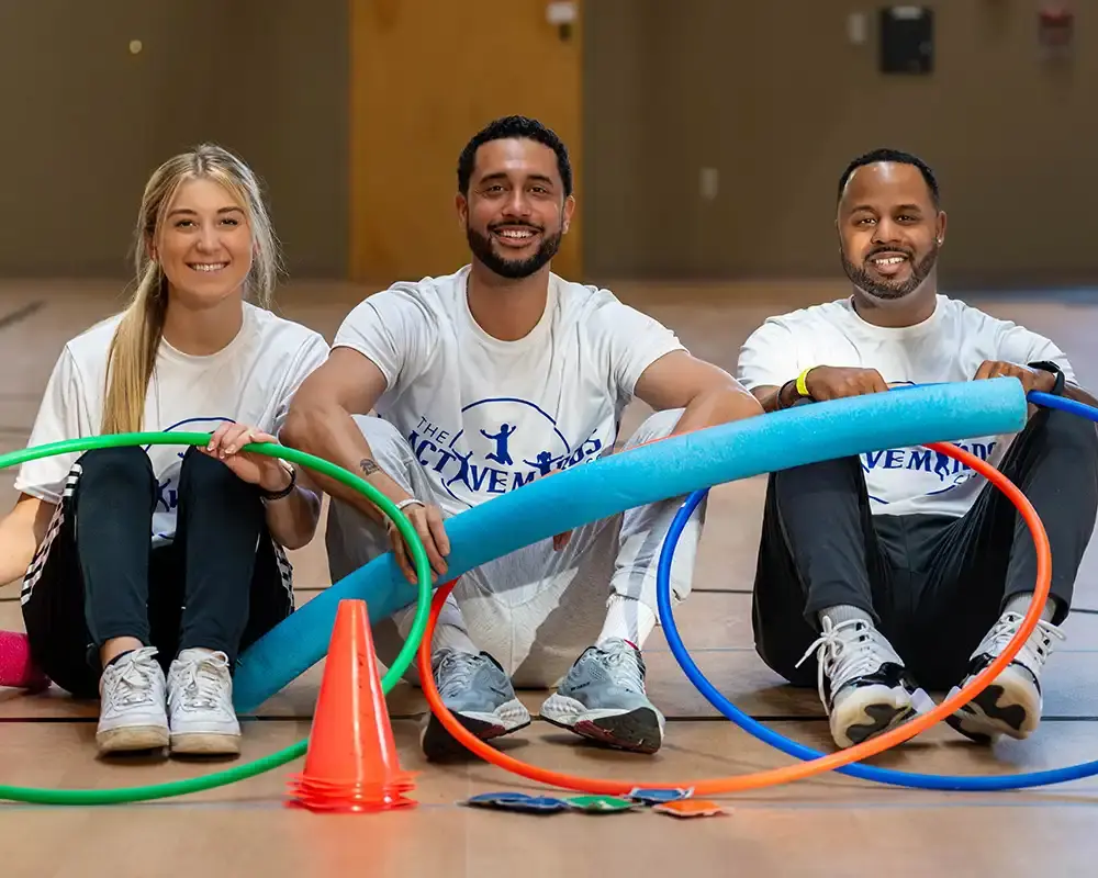 An AMC instructor with a foam noodle and a hulu hoop